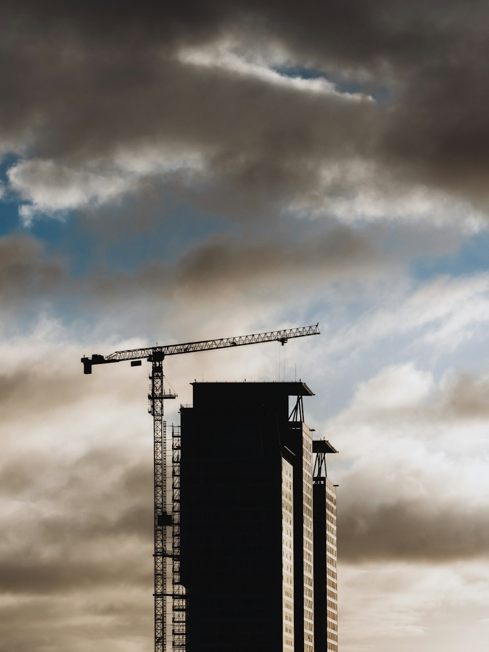 a tall building with a crane on top of it