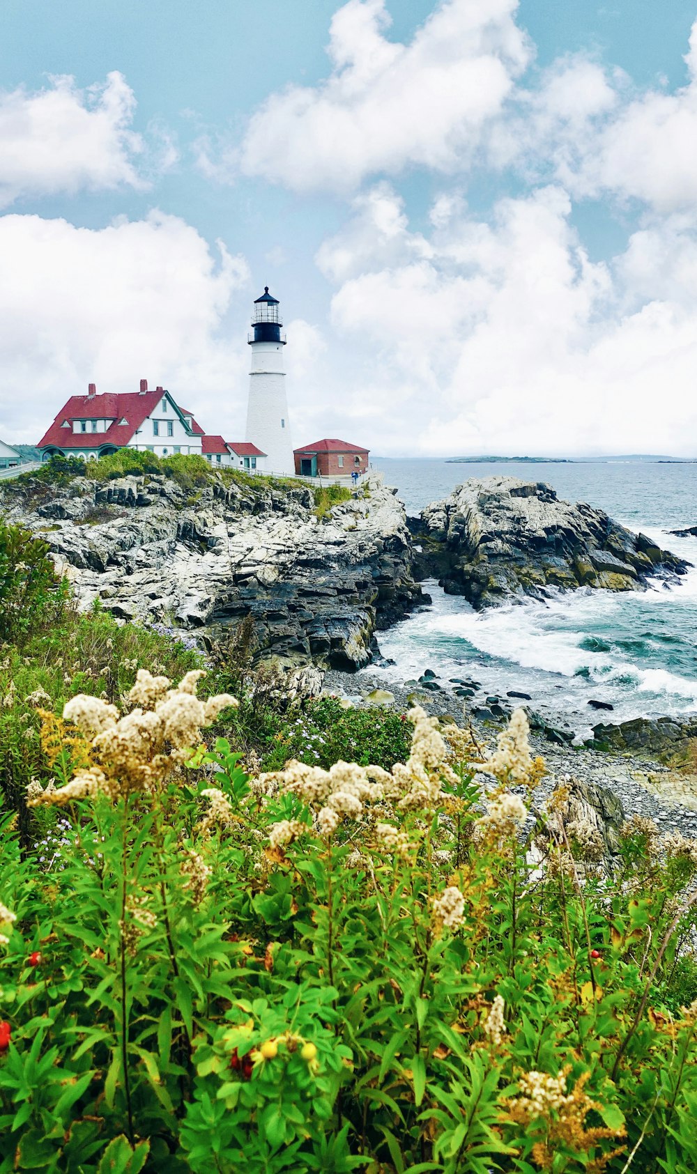 a light house sitting on top of a cliff next to the ocean