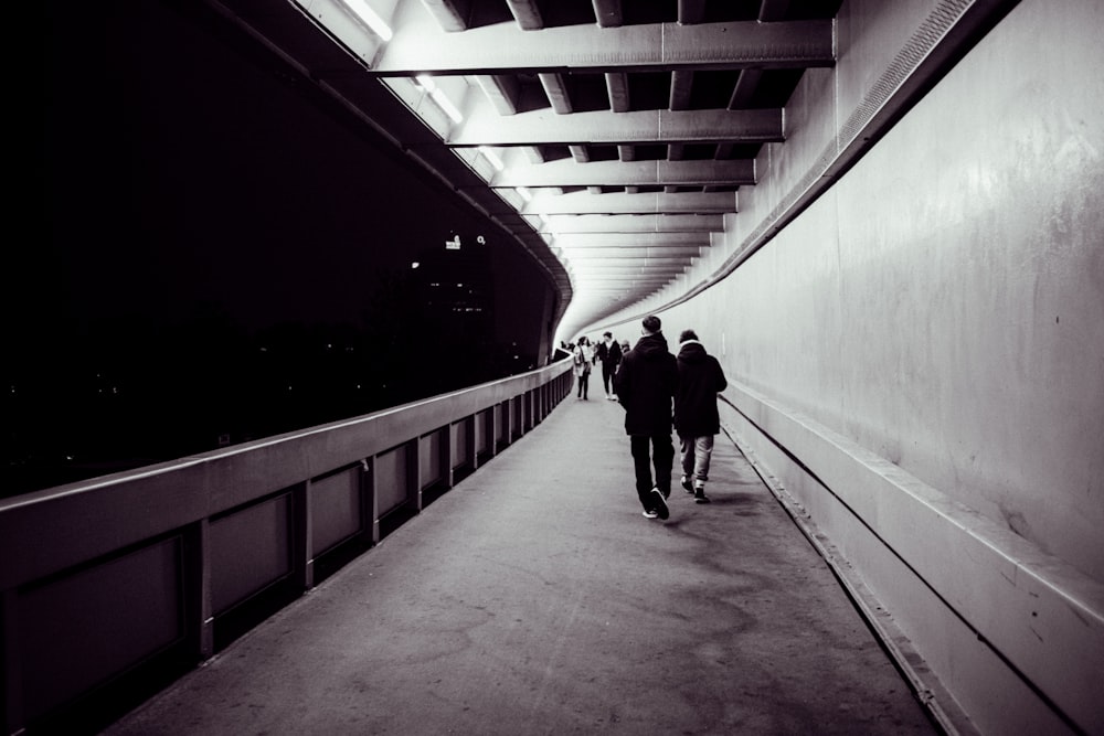 a group of people walking down a walkway