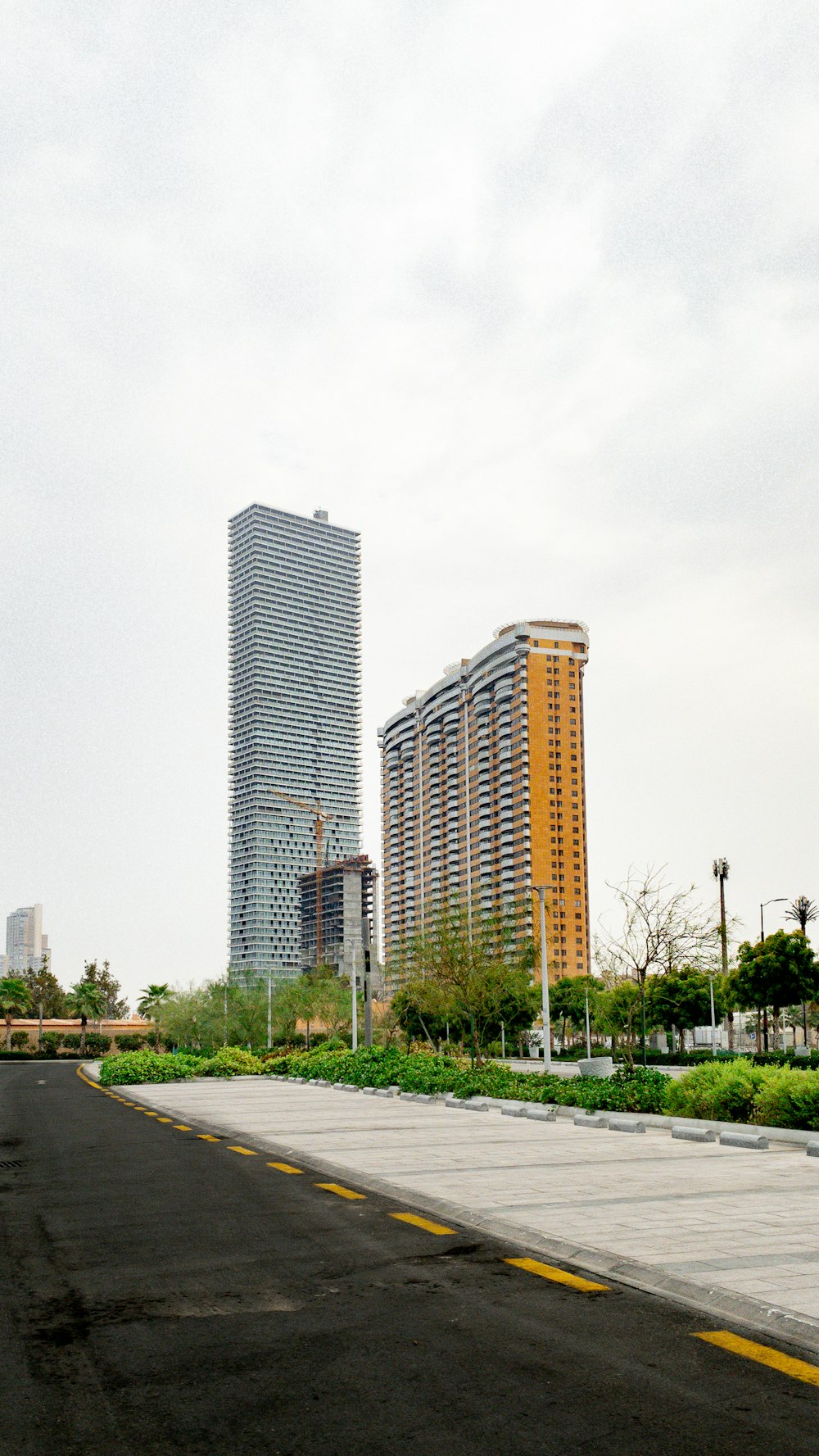 a city street with tall buildings in the background