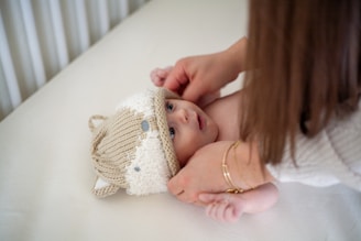 a woman holding a baby in her arms