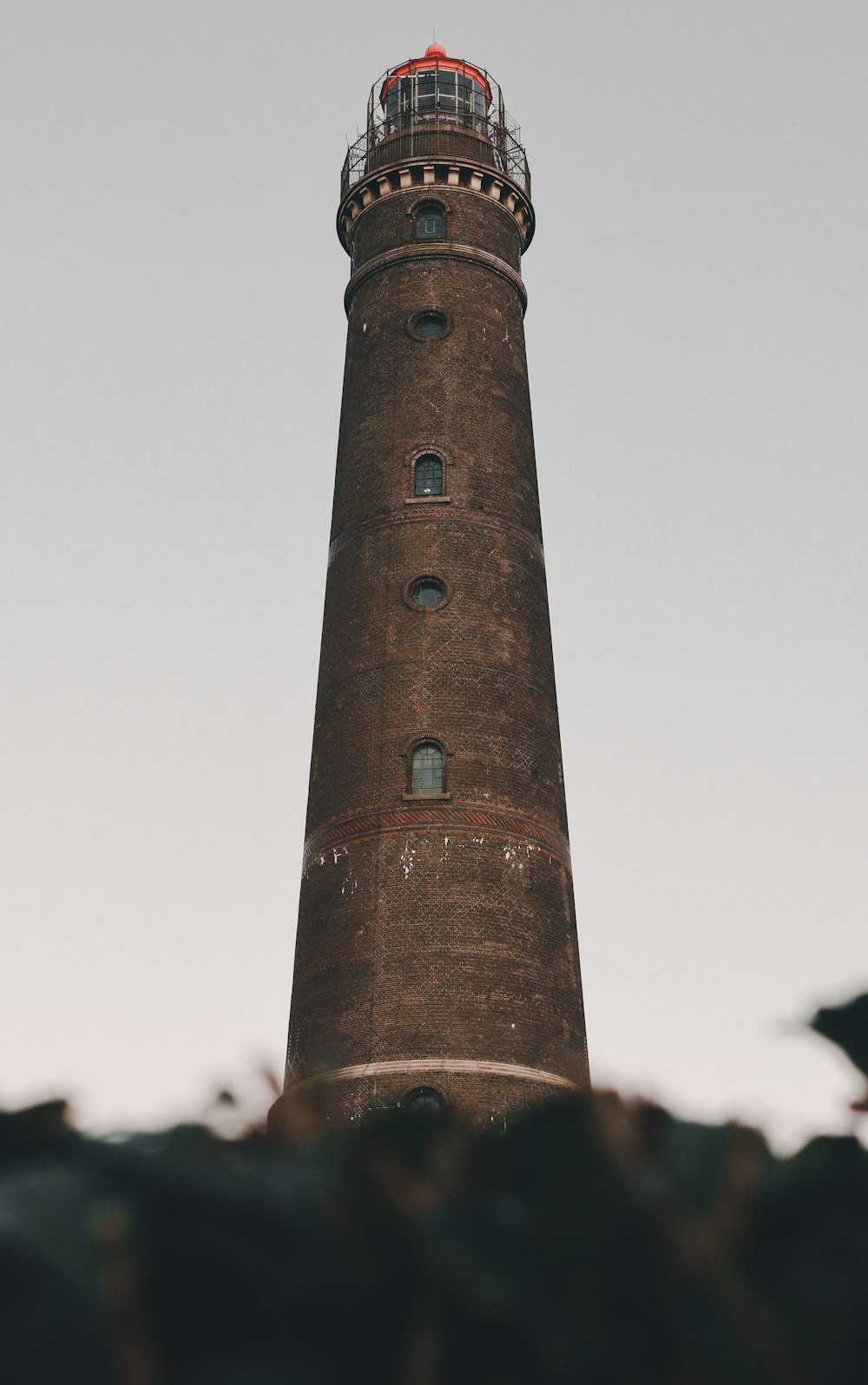 a tall brown tower with a red top