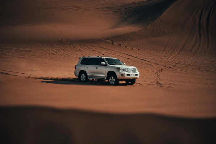 Vehicle on the sand dunes at golden hour