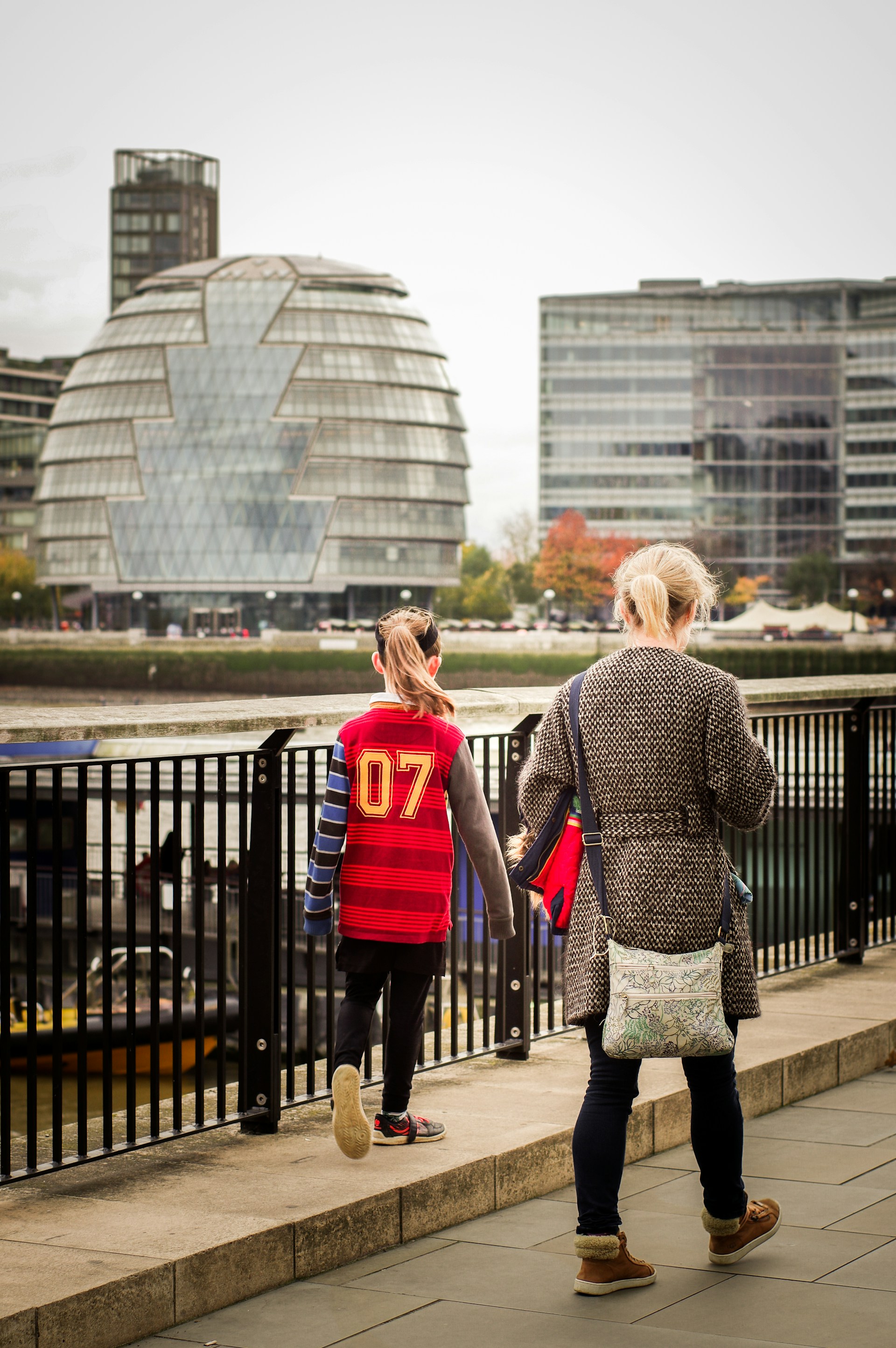 a couple of people walking down a sidewalk