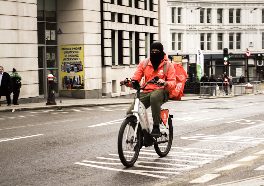 a man riding a bike down a street