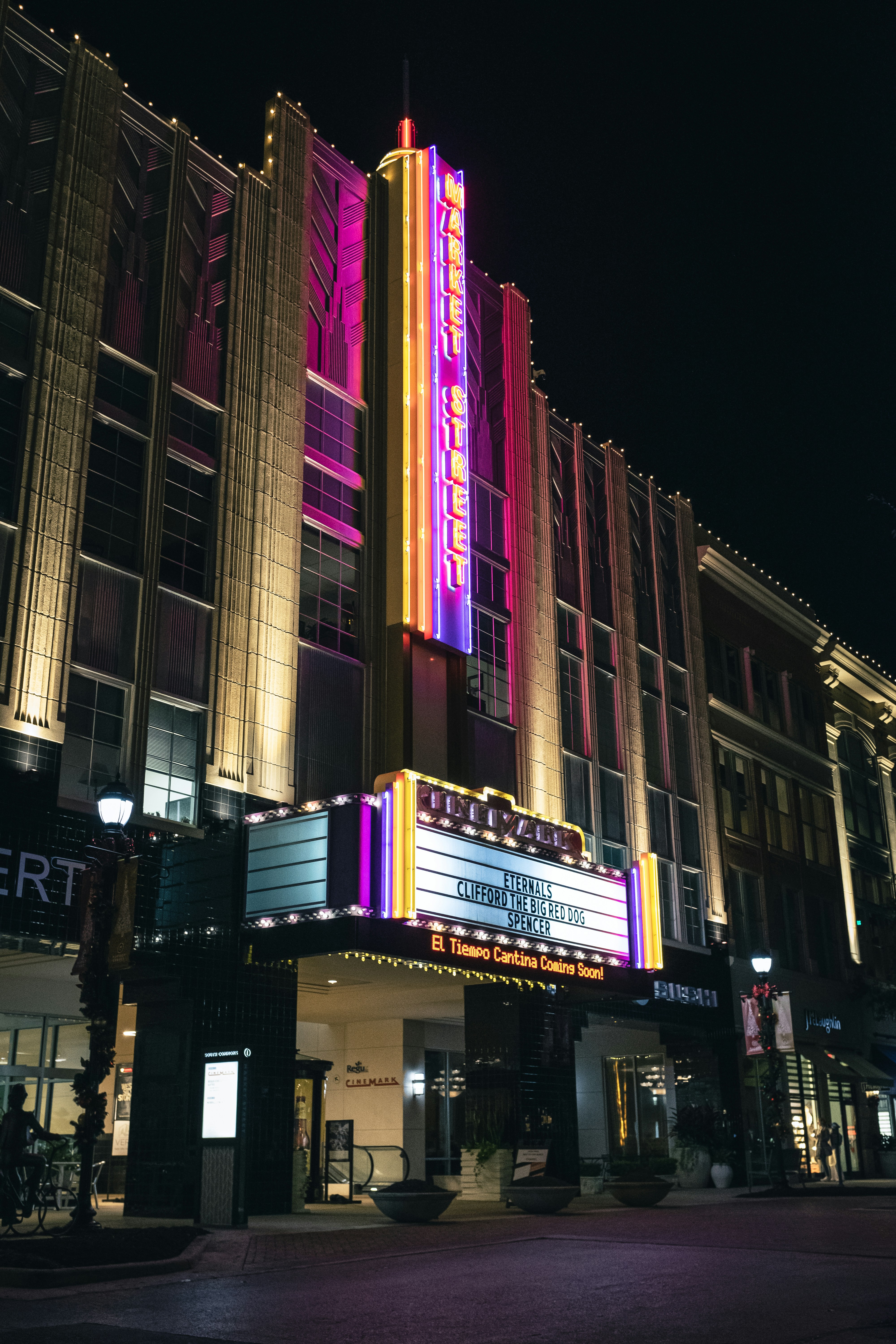 a large building with a large neon sign on it's side