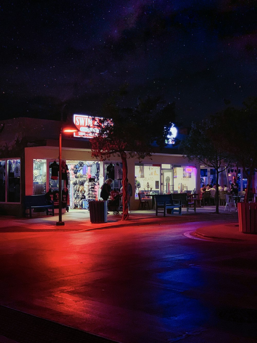 a red, white and blue light shines on a street