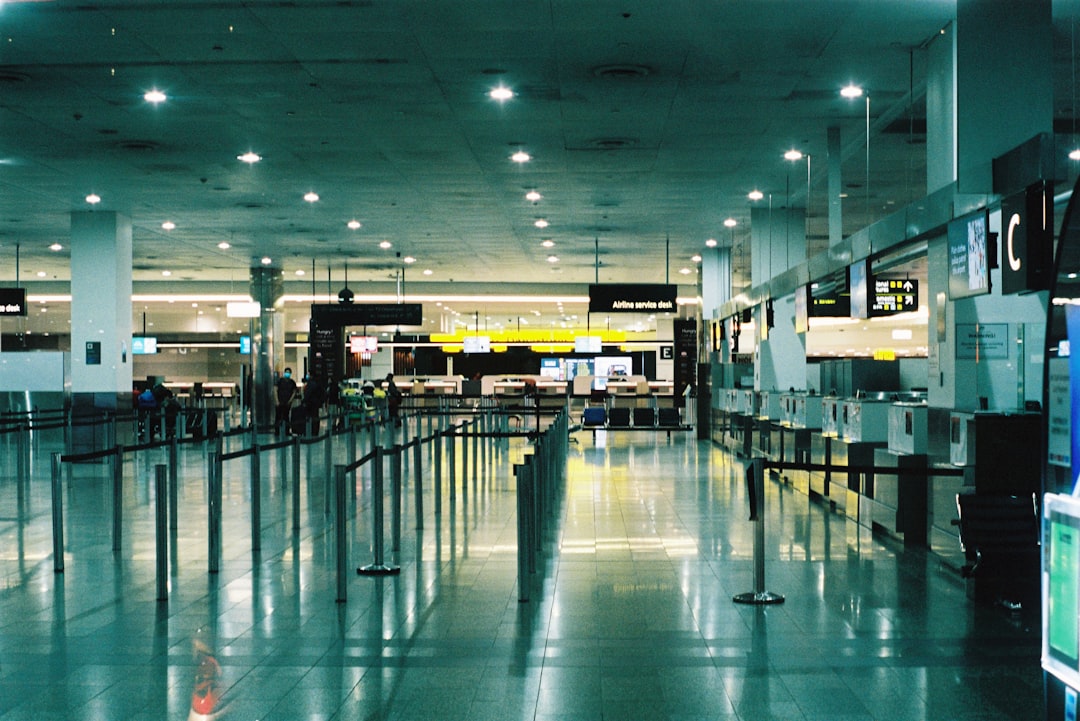 an empty airport terminal with people walking through it, Empty airport.