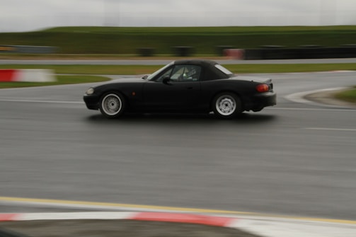 Dynamic shot of a modern F1 car speeding through a rain-soaked track.