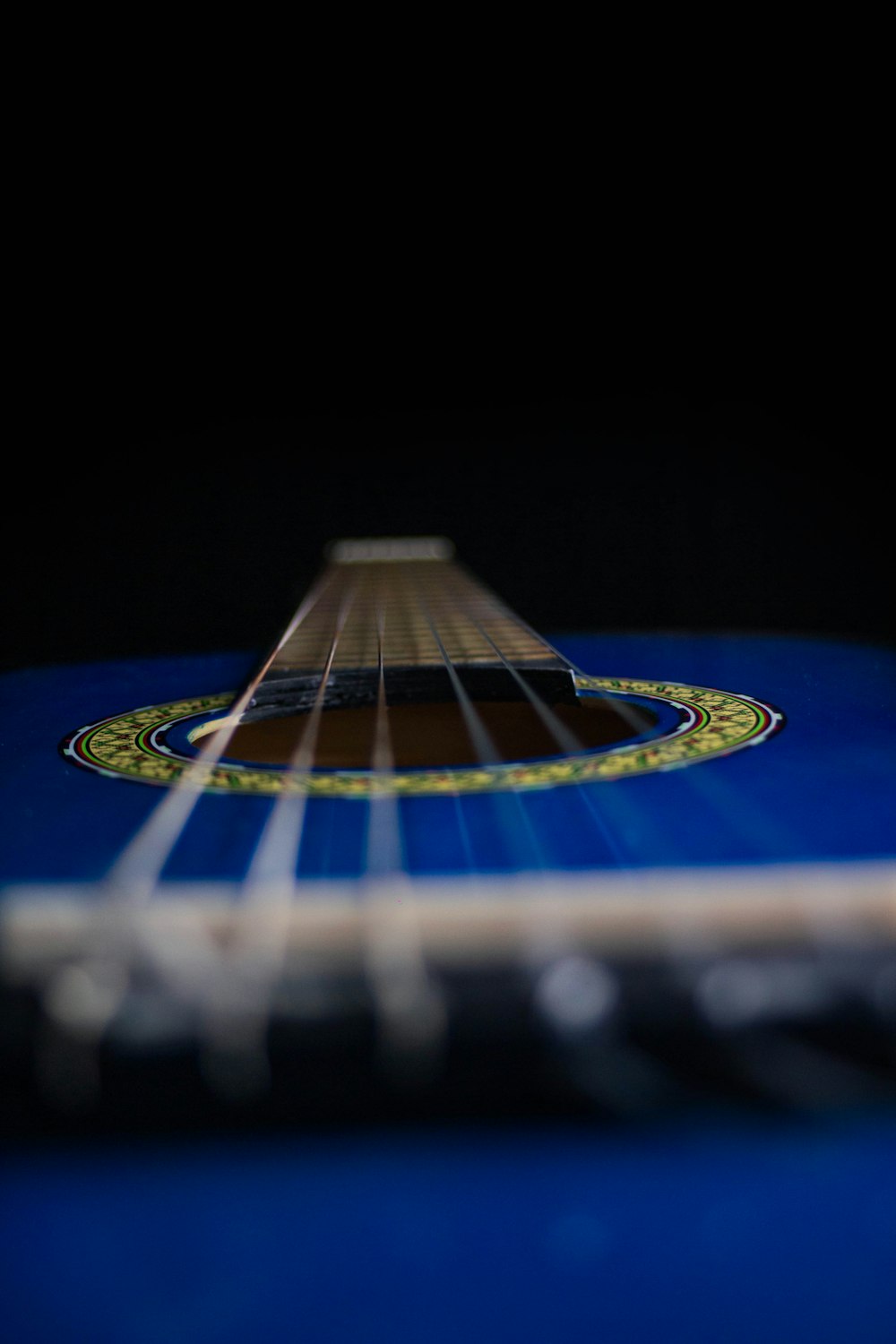 a close up of a blue acoustic guitar