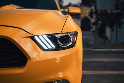 a close up of the front of a yellow sports car