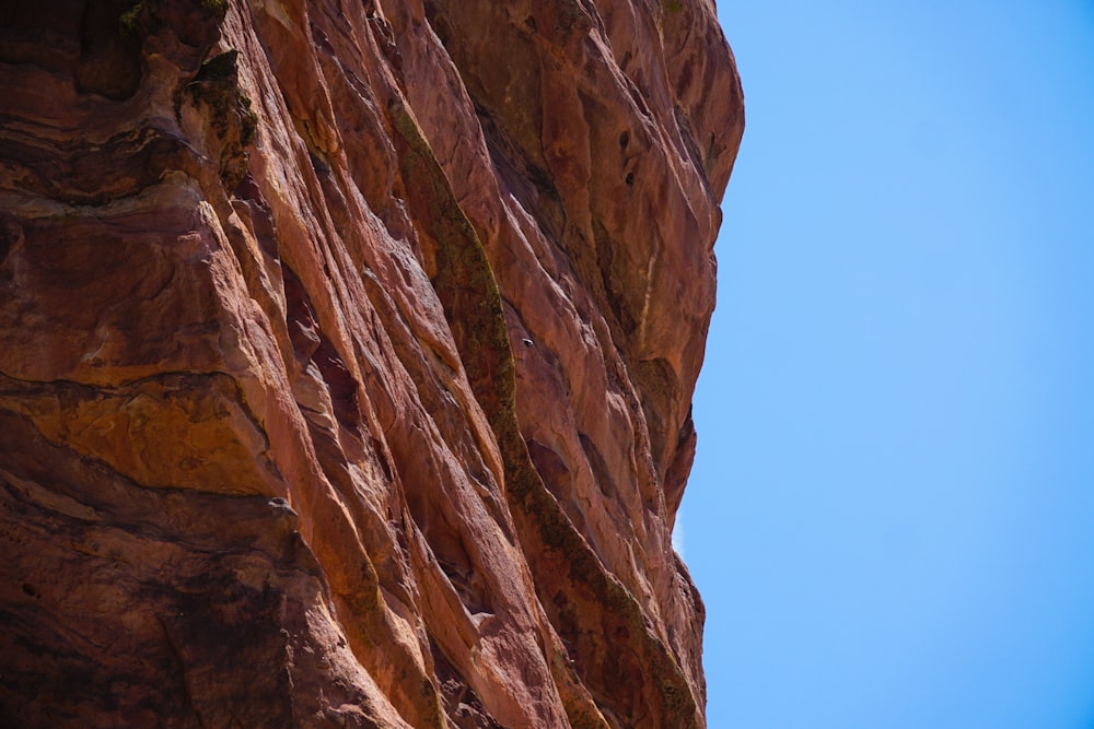 a man climbing up the side of a mountain