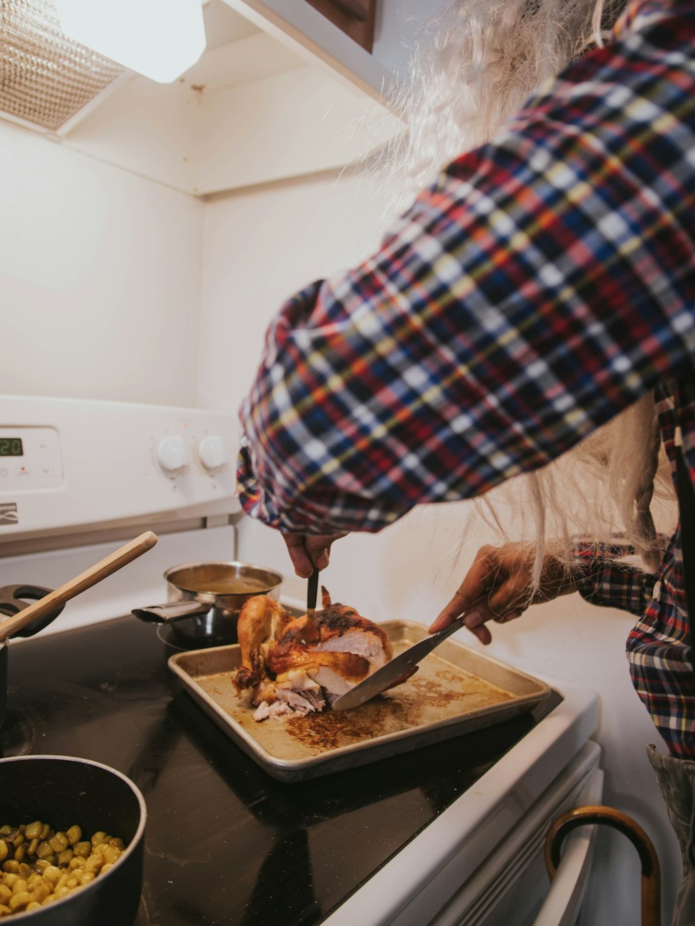 a person cutting a turkey on a cutting board