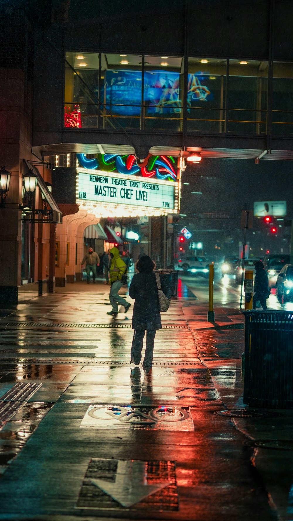 a person walking down a street in the rain