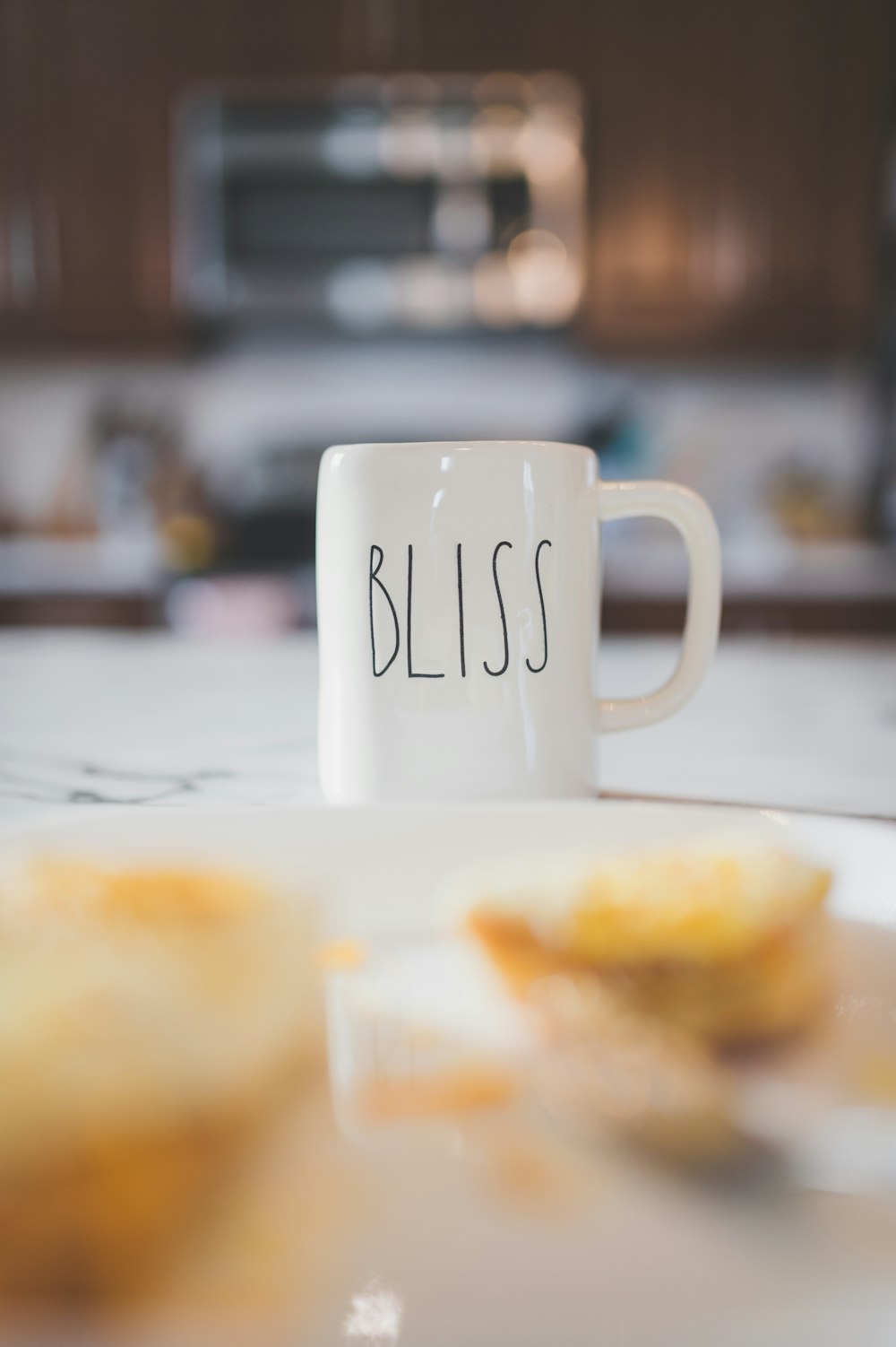 a white coffee mug sitting on top of a white plate