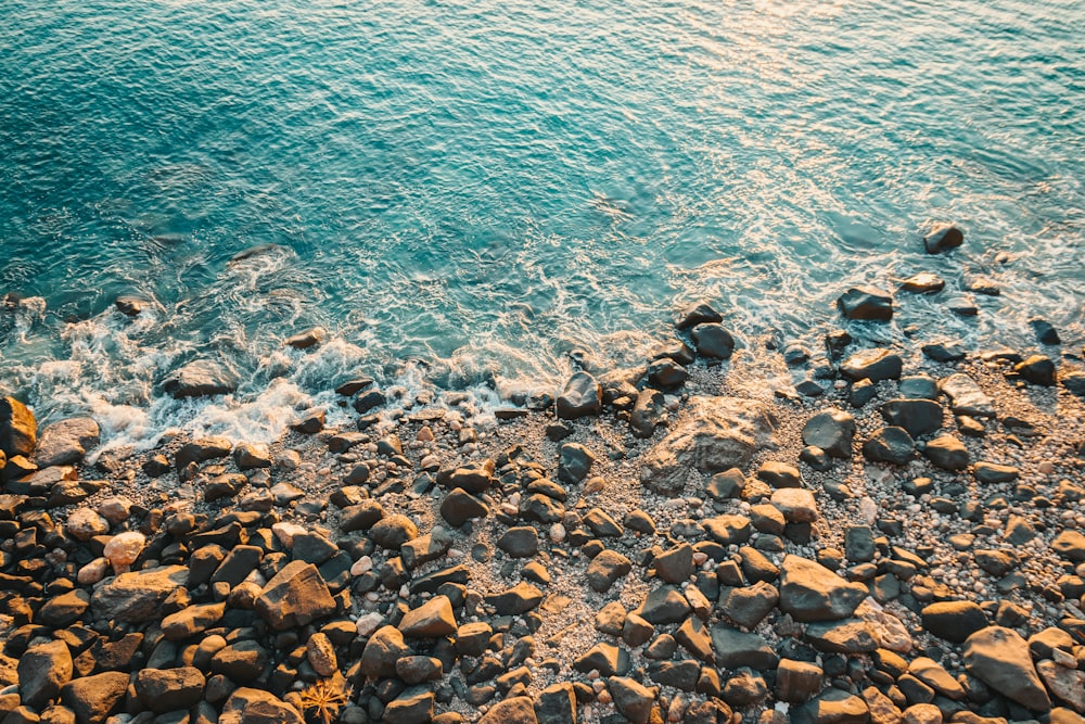 a view of a body of water with rocks in the foreground