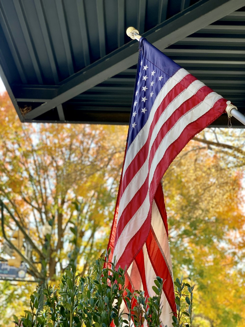 an american flag hanging from a metal roof