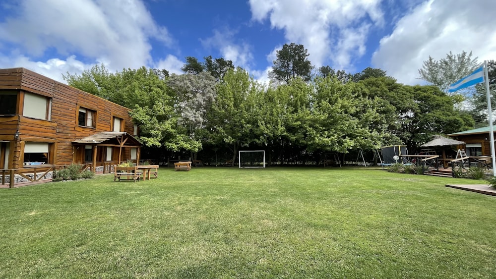 a grassy field with a soccer goal in the middle of it