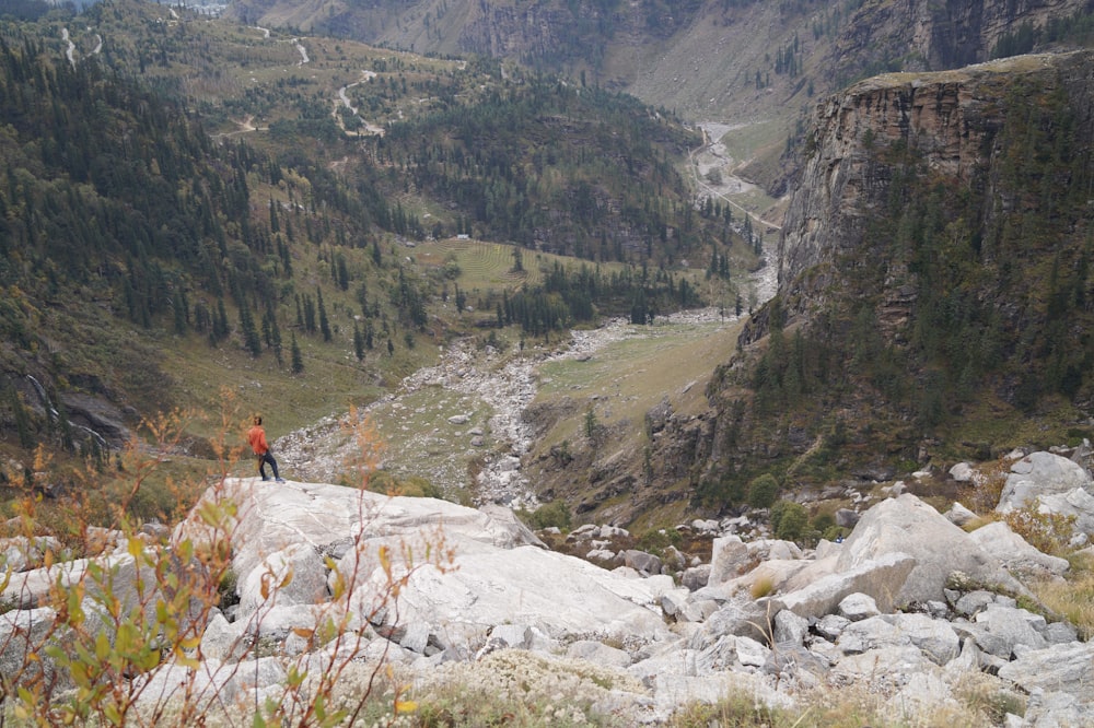 a man standing on top of a rocky hillside