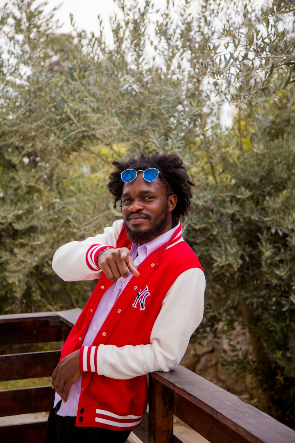 a man wearing a red and white jacket and sunglasses