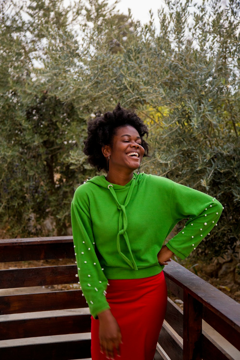 a woman in a green shirt and red skirt