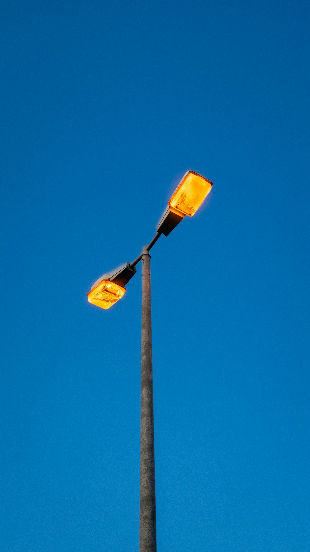 a street light with a blue sky in the background