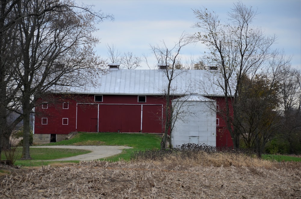 a red barn with a white door in a field