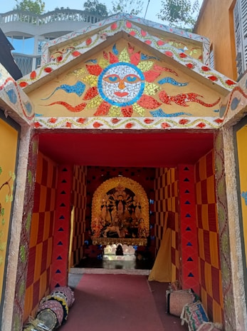 A vibrant entryway filled with uplifting colors and feng shui symbols welcoming abundance and joy.