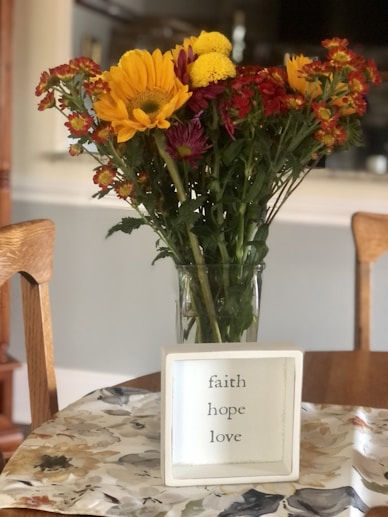 a vase filled with flowers sitting on top of a table