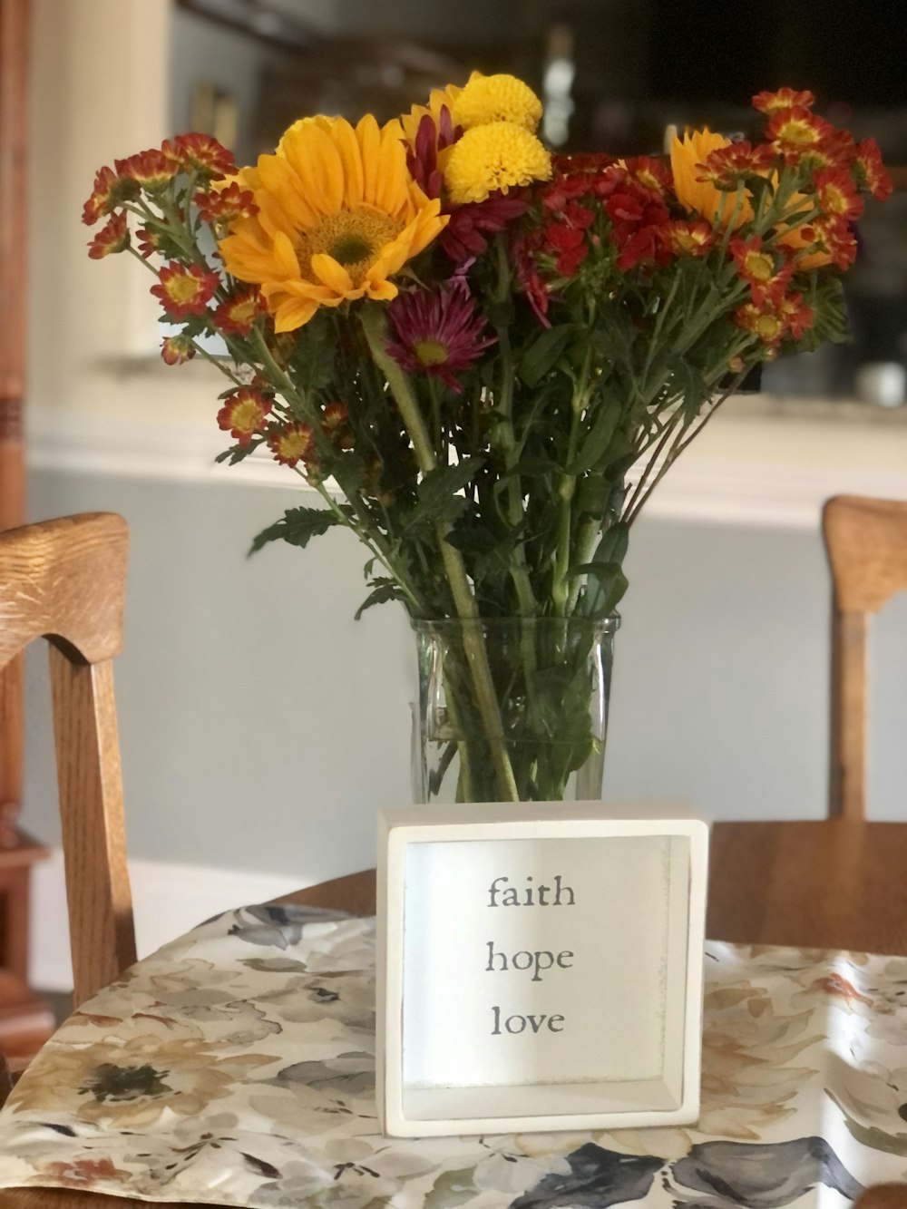 a vase filled with flowers sitting on top of a table