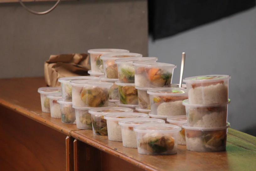 A close-up of colorful portion control containers neatly stacked on a kitchen counter.