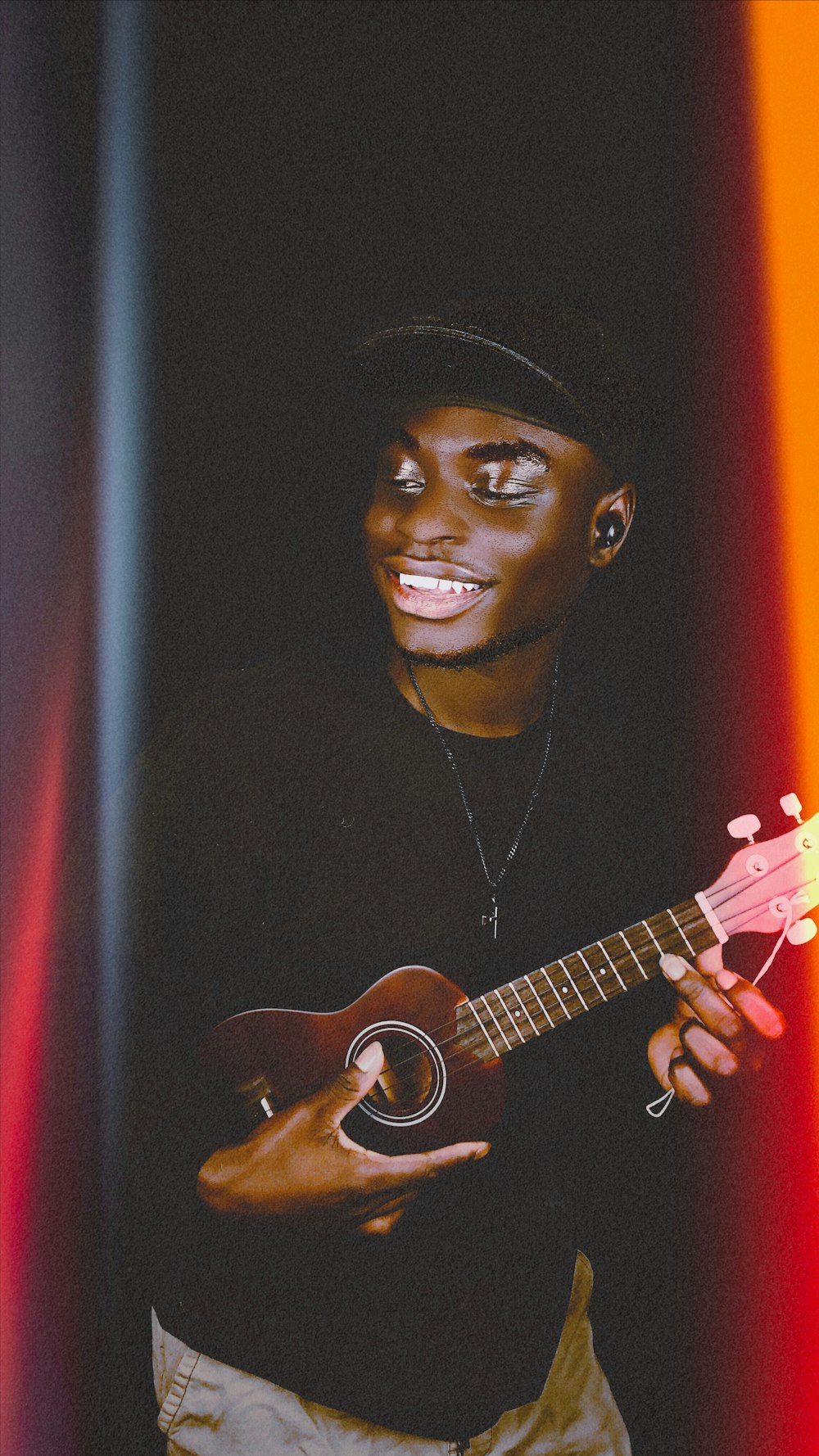 a man holding a guitar in his right hand