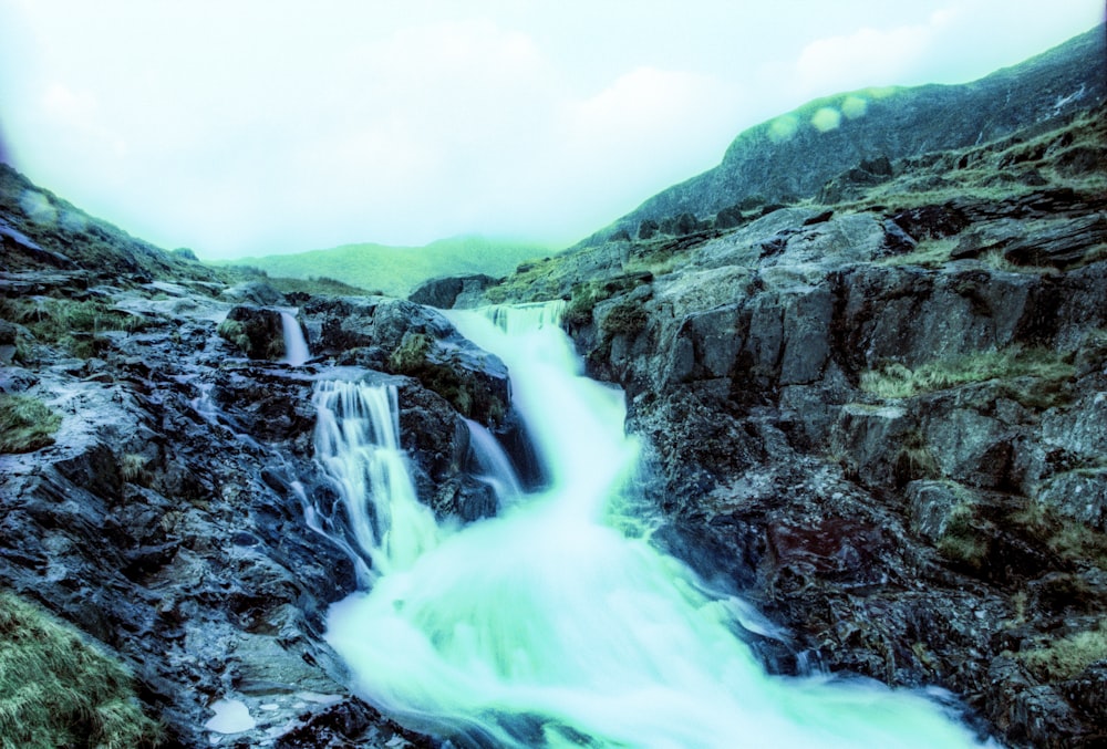 a waterfall in the middle of a rocky area