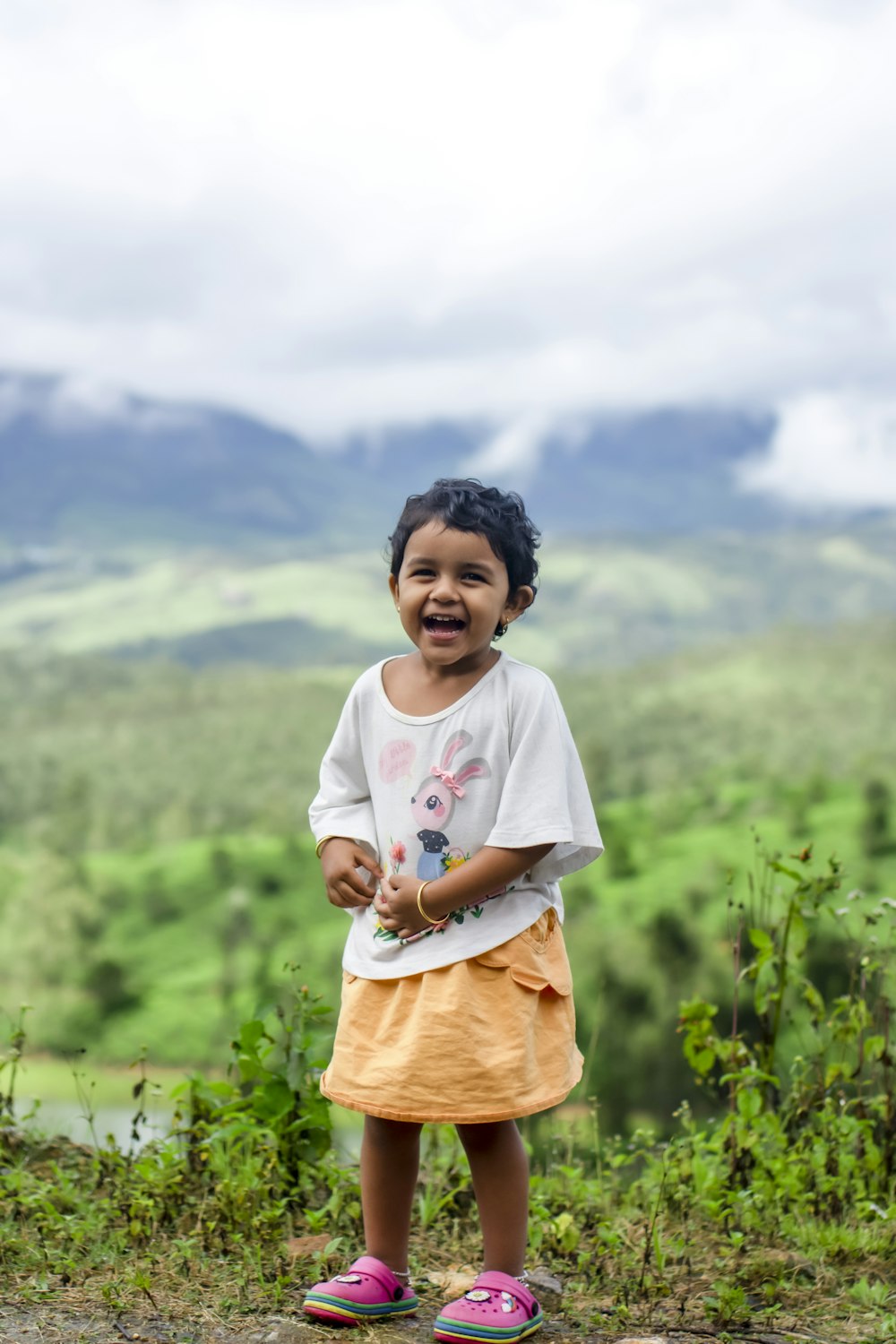 a little girl that is standing in the dirt