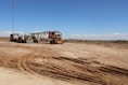 a couple of trucks that are sitting in the dirt