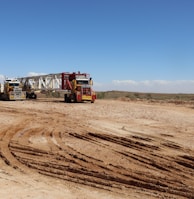 a couple of trucks that are sitting in the dirt