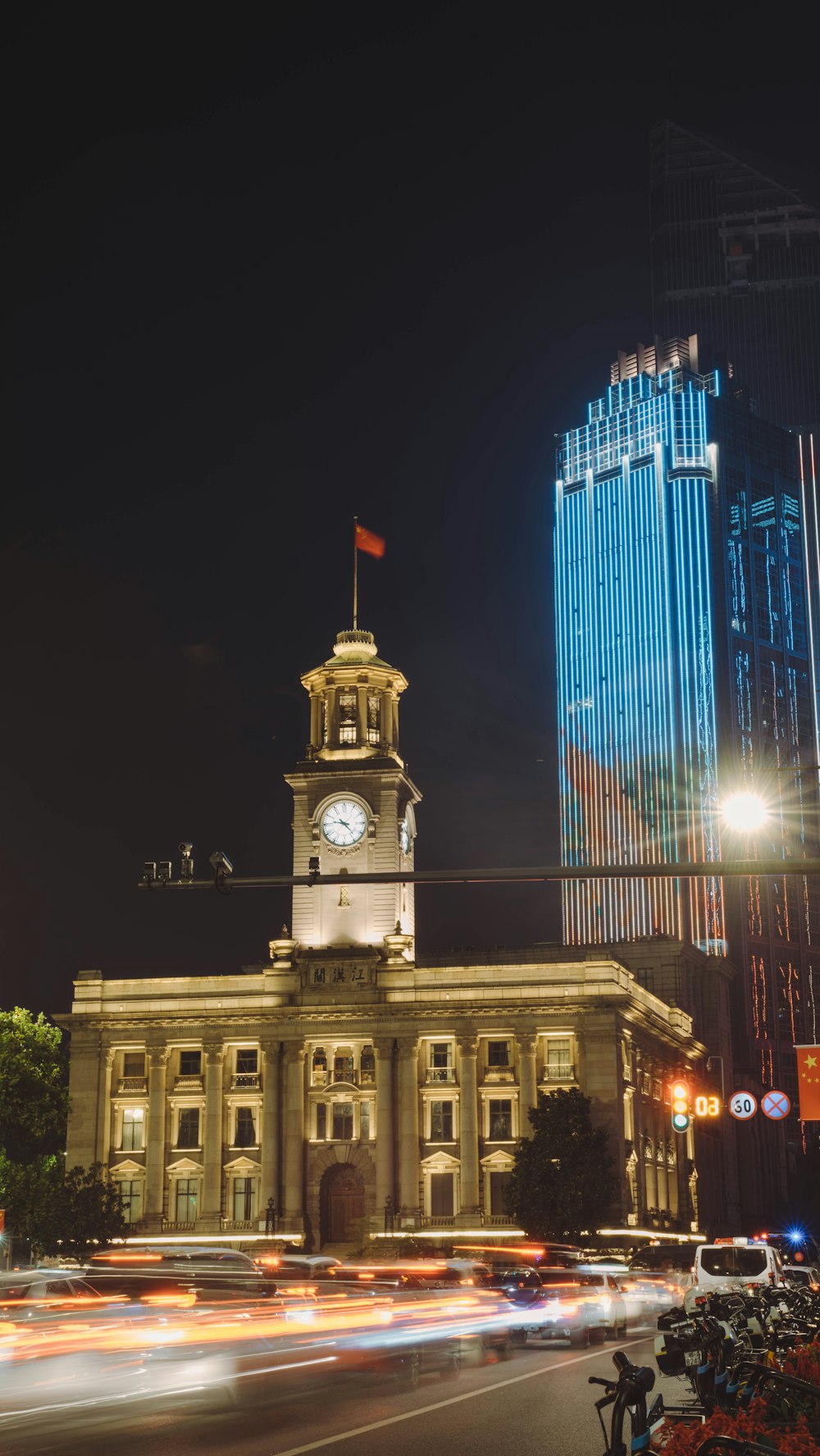 a large building with a clock tower at night