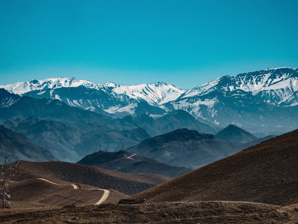 a view of a mountain range with a telephone pole in the foreground