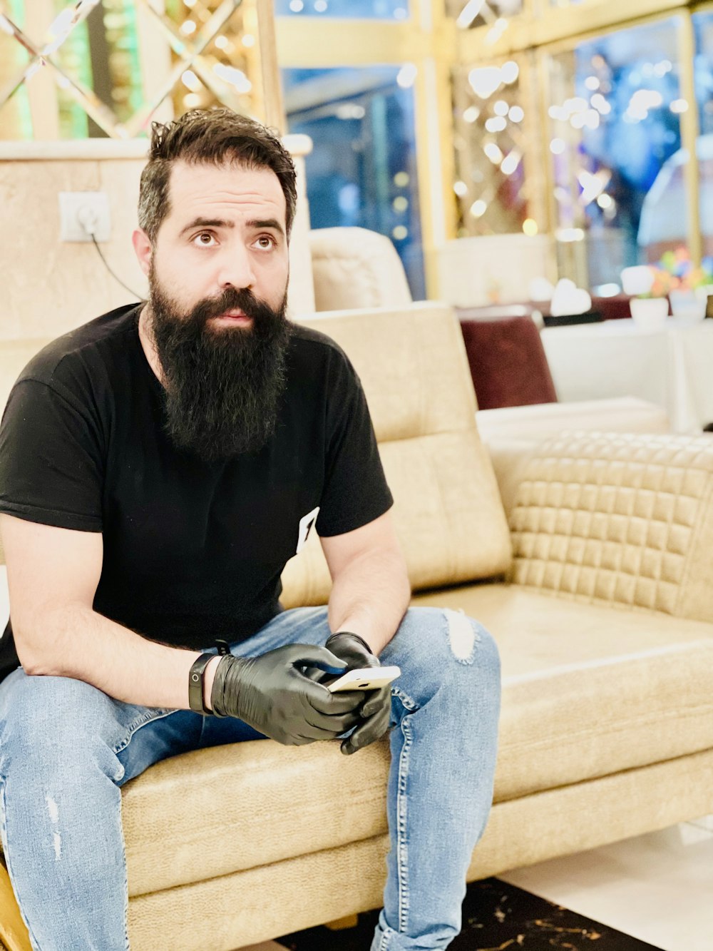 a man with a beard sitting on a couch