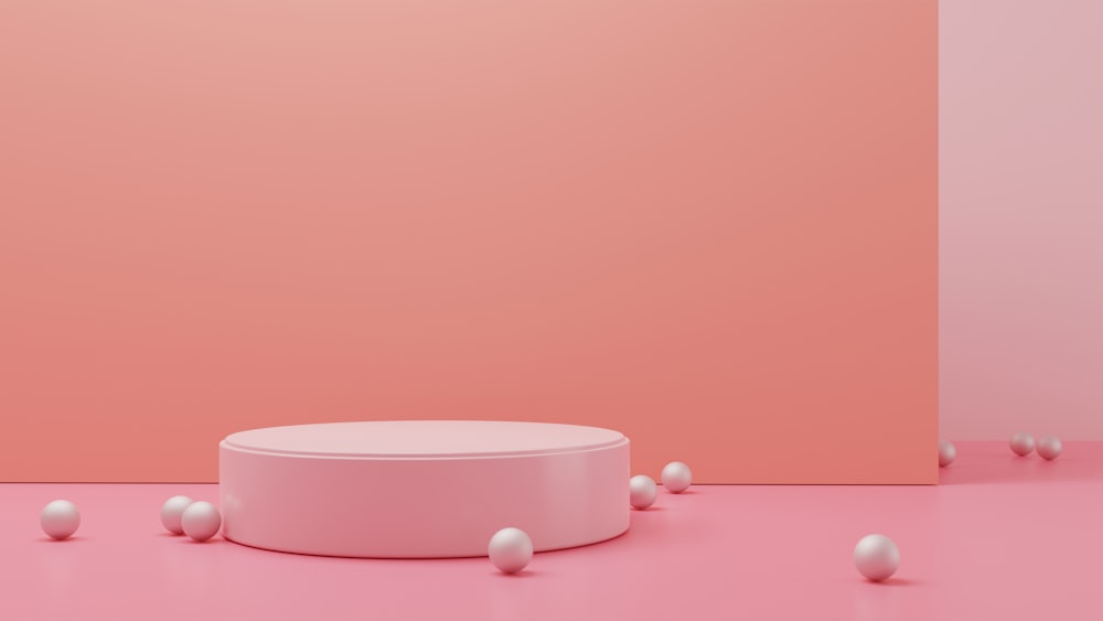 Una habitación rosa con una mesa redonda rodeada de bolas blancas
