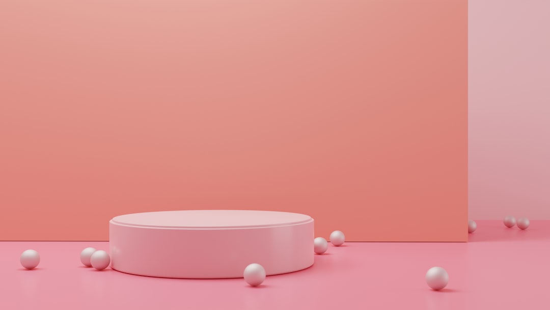 a pink room with a round table surrounded by white balls,