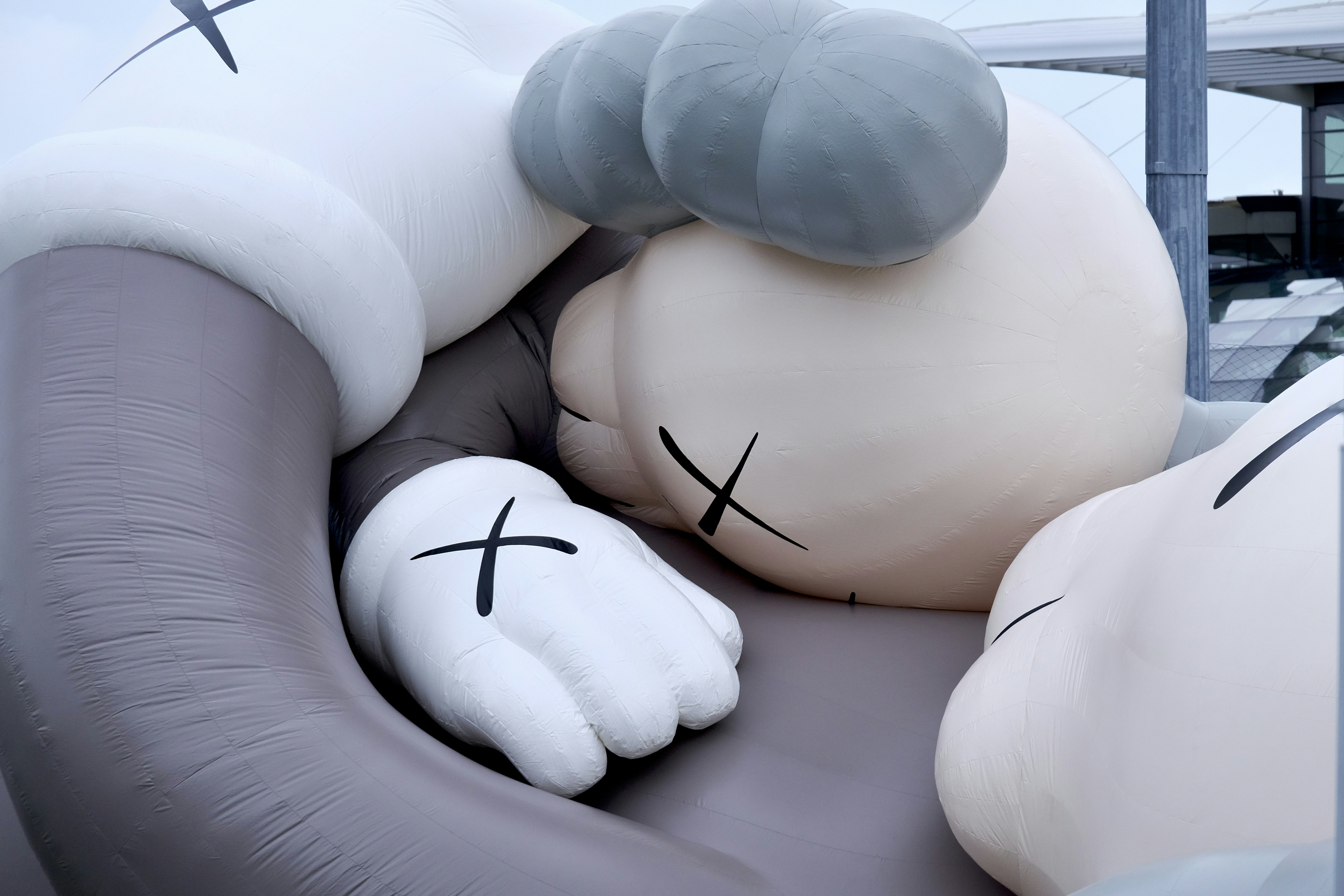 A large inflatable cat laying on top of a couch photo – Free Grey Image ...