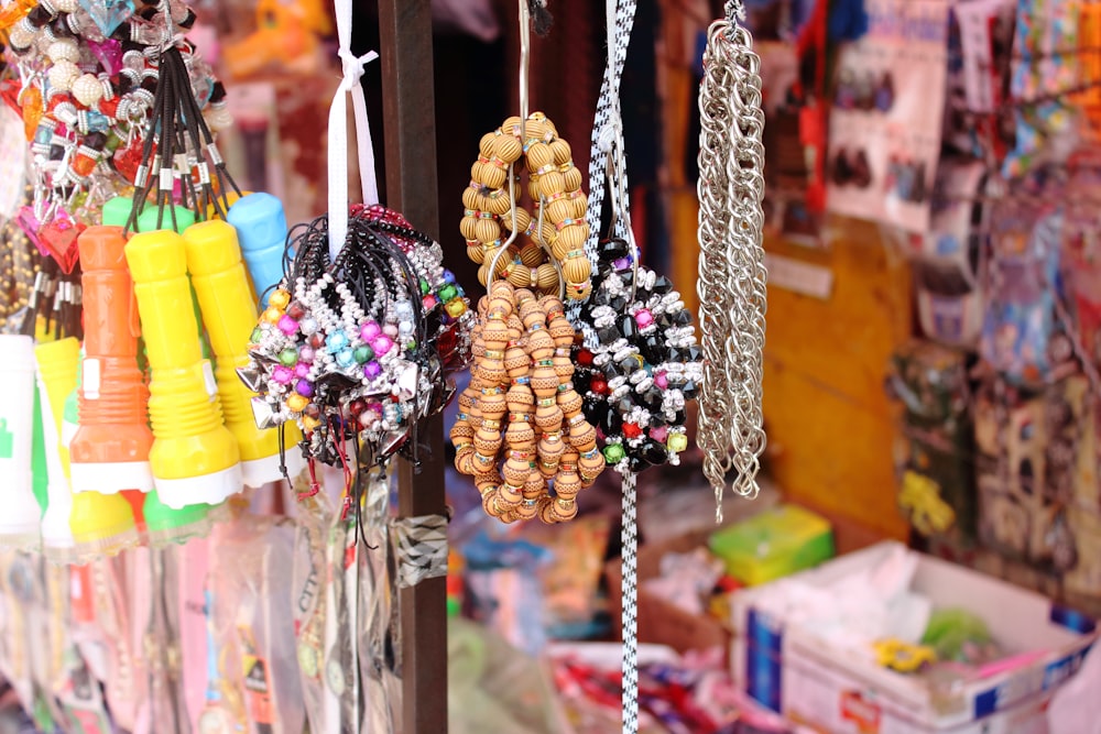 a bunch of necklaces are hanging on a rack