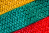 Close-up of textured fabric patterns showcasing intricate details and bold colors.