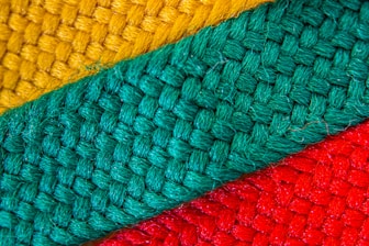 Close-up of colorful fabric pieces being transformed into new products.