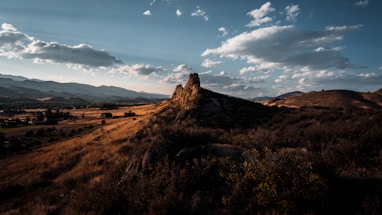 a hill with a large rock in the middle of it