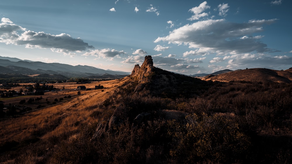 a hill with a large rock in the middle of it