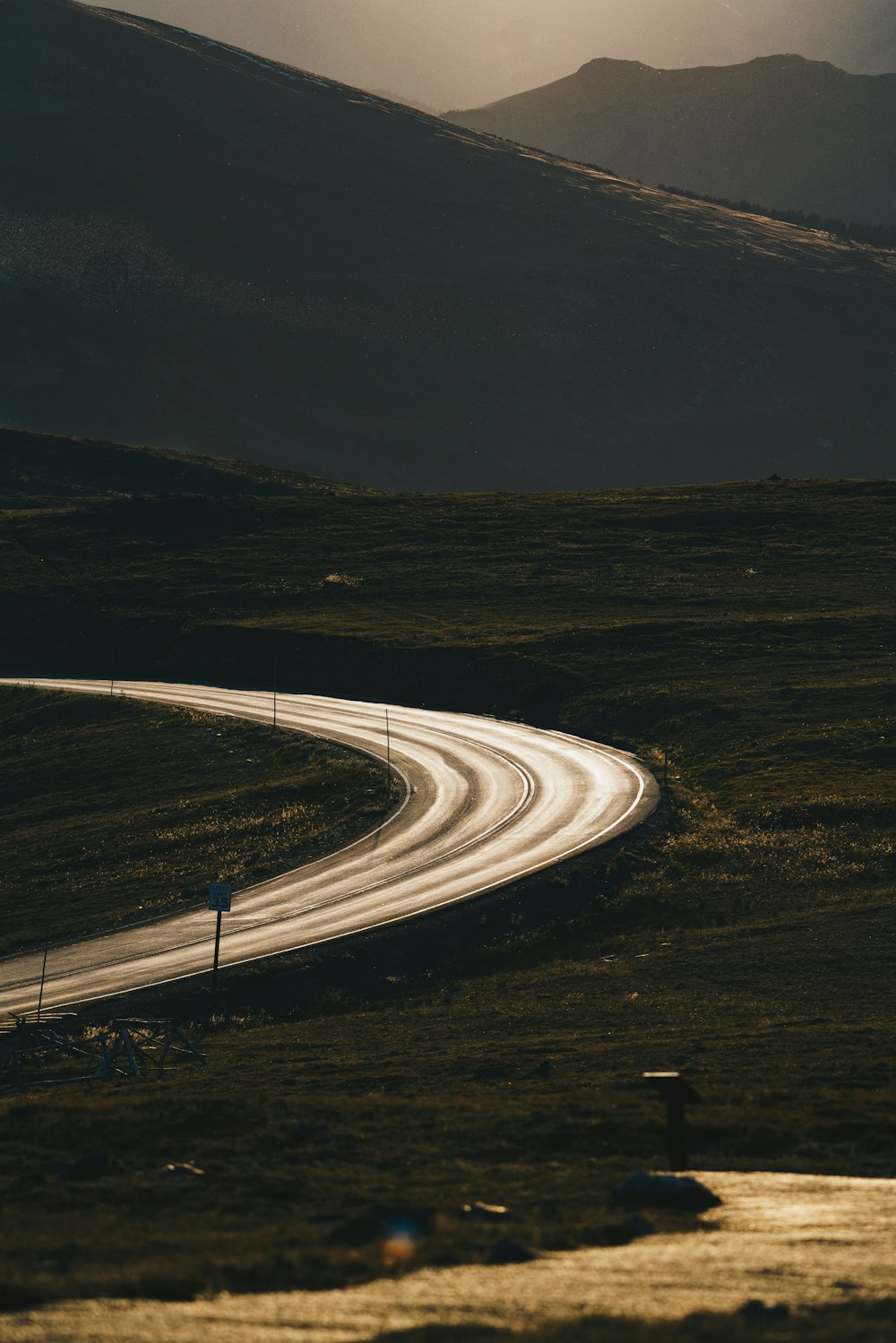 a winding road in the middle of a mountain range