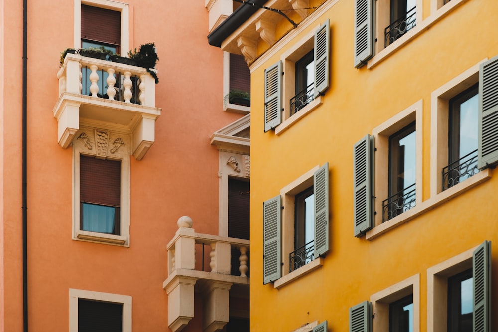 a tall building with balconies and a clock on it