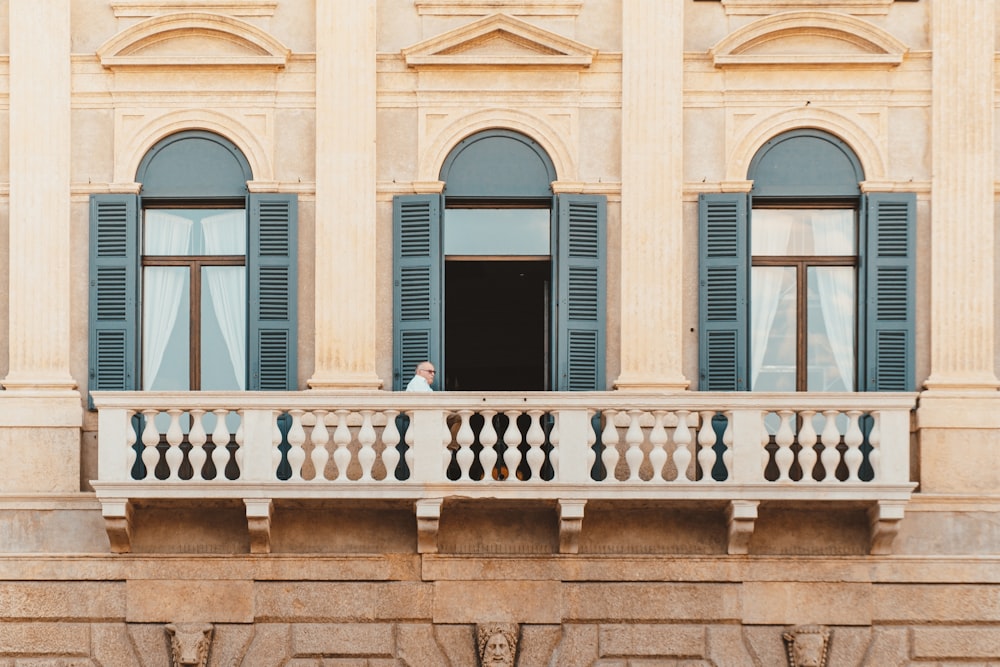 a man standing on a balcony of a building